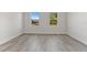 Well-lit bedroom with two windows and wood-look floors at 4479 Sw 170Th Rd, Ocala, FL 34473