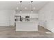 Modern kitchen with white cabinets, stainless steel appliances and island at 4479 Sw 170Th Rd, Ocala, FL 34473