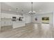 Open concept kitchen with island, stainless steel appliances, and white cabinetry at 4479 Sw 170Th Rd, Ocala, FL 34473