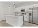 Modern kitchen with white cabinets, stainless steel appliances and island at 4479 Sw 170Th Rd, Ocala, FL 34473