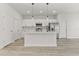 Modern kitchen with white cabinets, stainless steel appliances and island at 4479 Sw 170Th Rd, Ocala, FL 34473