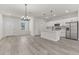 Open concept kitchen and dining area with stainless steel appliances and white shaker cabinets at 4479 Sw 170Th Rd, Ocala, FL 34473