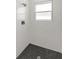 Clean and modern shower stall with hexagonal tile flooring and marble walls at 4479 Sw 170Th Rd, Ocala, FL 34473