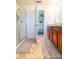 Main bathroom with double vanity, shower, and access to bedroom at 591 Preserve Pointe Blvd, Davenport, FL 33837