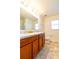 Double vanity bathroom with tiled floor and shower at 591 Preserve Pointe Blvd, Davenport, FL 33837