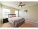 Bright bedroom with a queen-size bed, nightstand, and ceiling fan at 591 Preserve Pointe Blvd, Davenport, FL 33837