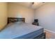 Bedroom with gray bedding, dark wood frame bed, and ceiling fan at 591 Preserve Pointe Blvd, Davenport, FL 33837