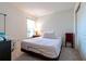 Bedroom with light bedding, bedside table, and window at 591 Preserve Pointe Blvd, Davenport, FL 33837