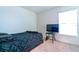 Bedroom with full bed, TV, and window at 591 Preserve Pointe Blvd, Davenport, FL 33837