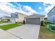 One-story house with gray garage door and landscaped front yard at 591 Preserve Pointe Blvd, Davenport, FL 33837