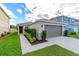 One-story house with gray garage door and landscaped front yard at 591 Preserve Pointe Blvd, Davenport, FL 33837