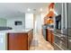 Modern kitchen with stainless steel appliances and wood cabinets at 591 Preserve Pointe Blvd, Davenport, FL 33837