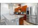 Kitchen with stainless steel appliances and wood cabinets at 591 Preserve Pointe Blvd, Davenport, FL 33837