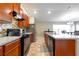Modern kitchen with stainless steel appliances and wood cabinets at 591 Preserve Pointe Blvd, Davenport, FL 33837