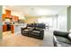 Open floor plan features a kitchen with stainless steel appliances and a living room with a comfortable couch at 591 Preserve Pointe Blvd, Davenport, FL 33837