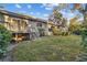 Rear view of house with deck and surrounding landscape at 6761 Trail Ridge Dr, Lakeland, FL 33813