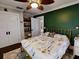 Serene bedroom with a gold metal bed frame and green accent wall at 705 E Pine St, Orlando, FL 32801