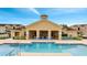 Community pool with lounge chairs and cabana at 718 Terrace Ridge Cir # 718, Davenport, FL 33896