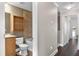 Clean bathroom with tub and shower, wood cabinet, and neutral tile at 7321 Brightland St, Windermere, FL 34786