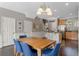 Dining area with wooden table and blue chairs, kitchen view at 7321 Brightland St, Windermere, FL 34786