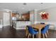 Light and bright dining area with a wooden table and blue chairs at 7321 Brightland St, Windermere, FL 34786
