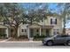 Two story townhome with front yard landscaping and a gray SUV parked in front at 7321 Brightland St, Windermere, FL 34786