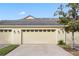 Attached two-car garage with neutral-colored doors at 7321 Brightland St, Windermere, FL 34786