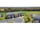Modern townhomes nestled near a golf course and lush greenery at 856 Driving Range Ct, Reunion, FL 34747