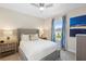 Comfortable guest bedroom with a queen-size bed and large window at 856 Driving Range Ct, Reunion, FL 34747