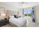 Spacious bedroom with large window and plush bed at 856 Driving Range Ct, Reunion, FL 34747