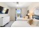 Cozy bedroom with two twin beds, a dresser and large window at 856 Driving Range Ct, Reunion, FL 34747