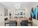 Open dining room with modern light fixture and kitchen views at 856 Driving Range Ct, Reunion, FL 34747