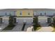 Three-unit townhome building with attached garages and landscaped grounds at 856 Driving Range Ct, Reunion, FL 34747