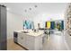Open concept kitchen with island and views into living room at 856 Driving Range Ct, Reunion, FL 34747