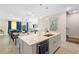 Open concept kitchen with island, stainless steel appliances and modern decor at 856 Driving Range Ct, Reunion, FL 34747