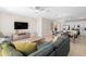 Open concept living space showcasing a sectional sofa and kitchen at 856 Driving Range Ct, Reunion, FL 34747
