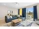 Bright living room with comfortable sectional sofa and access to a patio at 856 Driving Range Ct, Reunion, FL 34747