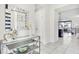 Bright and airy entryway with glass-top console table and large mirror at 8921 Sydney Ave, Kissimmee, FL 34747