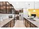 Modern kitchen with dark wood cabinets, granite countertops, and stainless steel appliances at 8921 Sydney Ave, Kissimmee, FL 34747