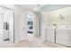 Upper-level laundry room with washer, dryer, and built-in shelving at 8921 Sydney Ave, Kissimmee, FL 34747