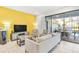 Living room with comfortable seating and access to backyard and pool at 8921 Sydney Ave, Kissimmee, FL 34747