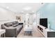 Upstairs loft area with gray couch and TV, perfect for additional living space at 8921 Sydney Ave, Kissimmee, FL 34747