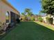 Backyard with lush green lawn, landscaping, and privacy fence at 9111 Woodbridge Oak Ter, Orlando, FL 32825