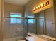 Bathroom with shower/tub combo, vanity with mirror, and light fixture at 9111 Woodbridge Oak Ter, Orlando, FL 32825