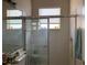 Bathroom with shower stall, window with blinds, and tile flooring at 9111 Woodbridge Oak Ter, Orlando, FL 32825