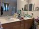 Double vanity bathroom with a large mirror and good counter space at 9111 Woodbridge Oak Ter, Orlando, FL 32825