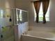 Bathroom with soaking tub, shower, and updated vanity at 9111 Woodbridge Oak Ter, Orlando, FL 32825