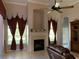 Cozy Gathering room with a fireplace and built-in shelving at 9111 Woodbridge Oak Ter, Orlando, FL 32825