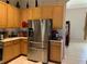 Kitchen boasts stainless steel refrigerator and wood cabinets at 9111 Woodbridge Oak Ter, Orlando, FL 32825