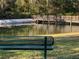 Wooden footbridge over calm lake, serene setting at 9111 Woodbridge Oak Ter, Orlando, FL 32825